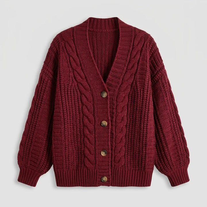 Women's oversized cardigan flat lay close-up showing cable knit texture
