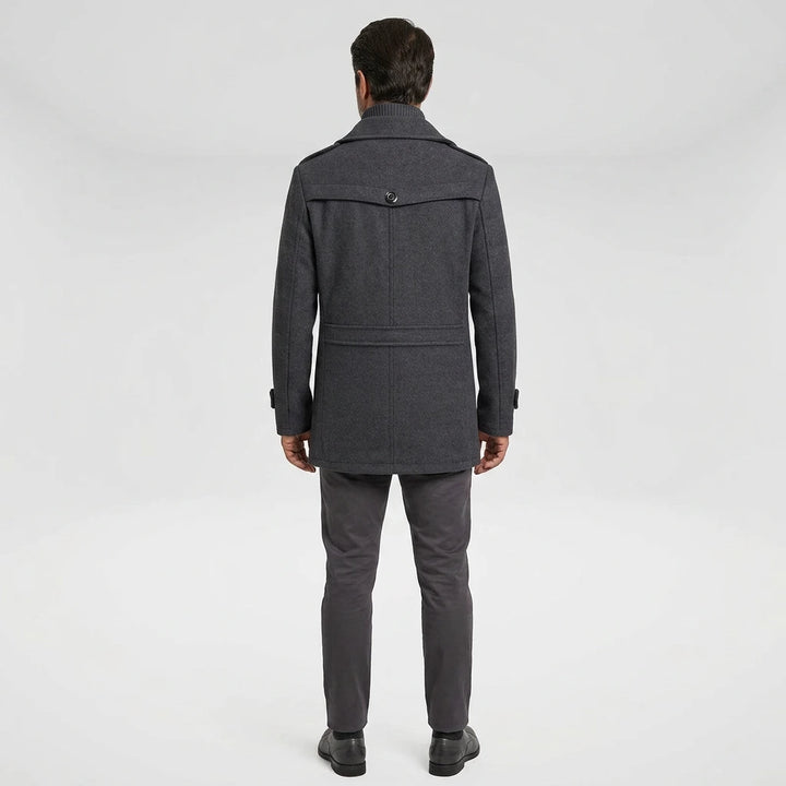 Man wearing gray men's winter overcoat — back view showing yoke seam and epaulettes