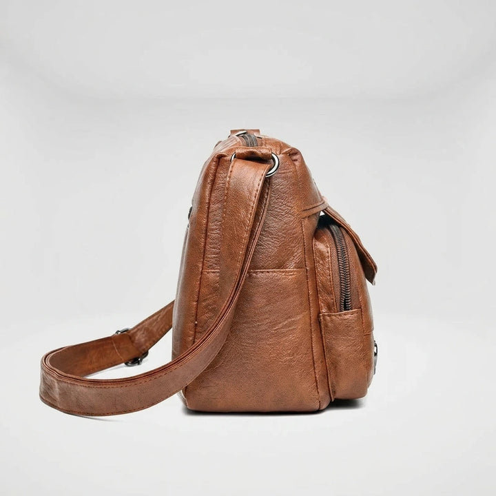 Side profile of brown shoulder bag showing depth and clean stitching