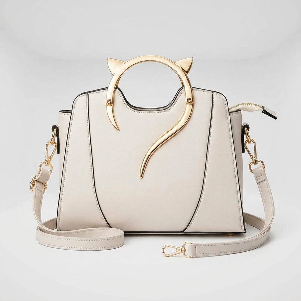 Women's handbag with cat handle — top-down view showing gold cat-ear ring handle and structured black PU exterior
