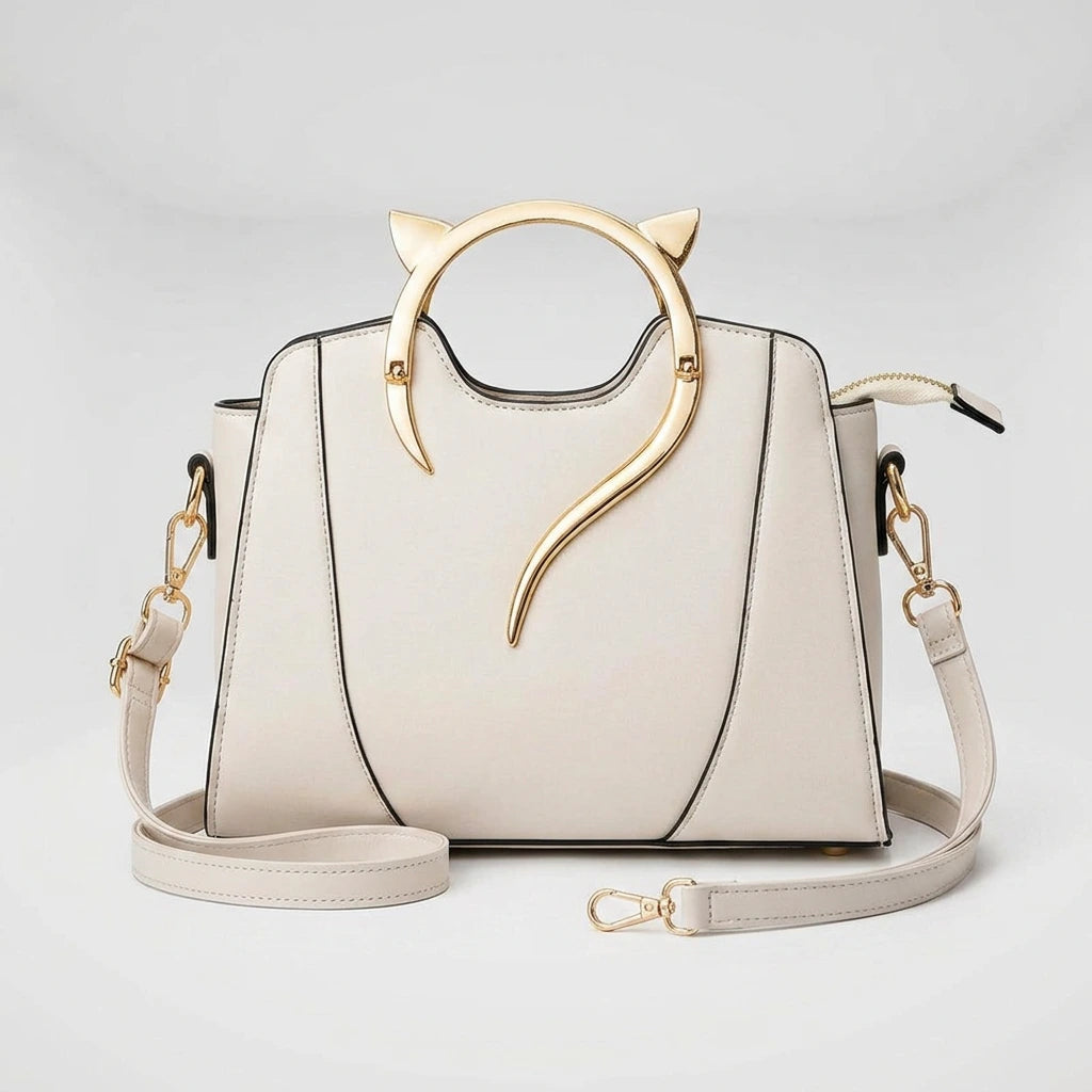 Women's handbag with cat handle — top-down view showing gold cat-ear ring handle and structured black PU exterior